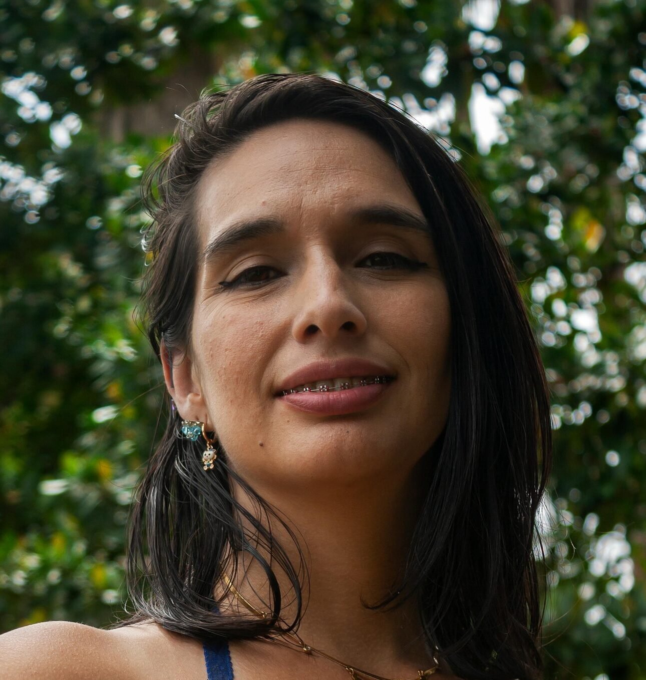 Smiling woman in yellow dress enjoying a sunny day outdoors in Mérida, Venezuela.
